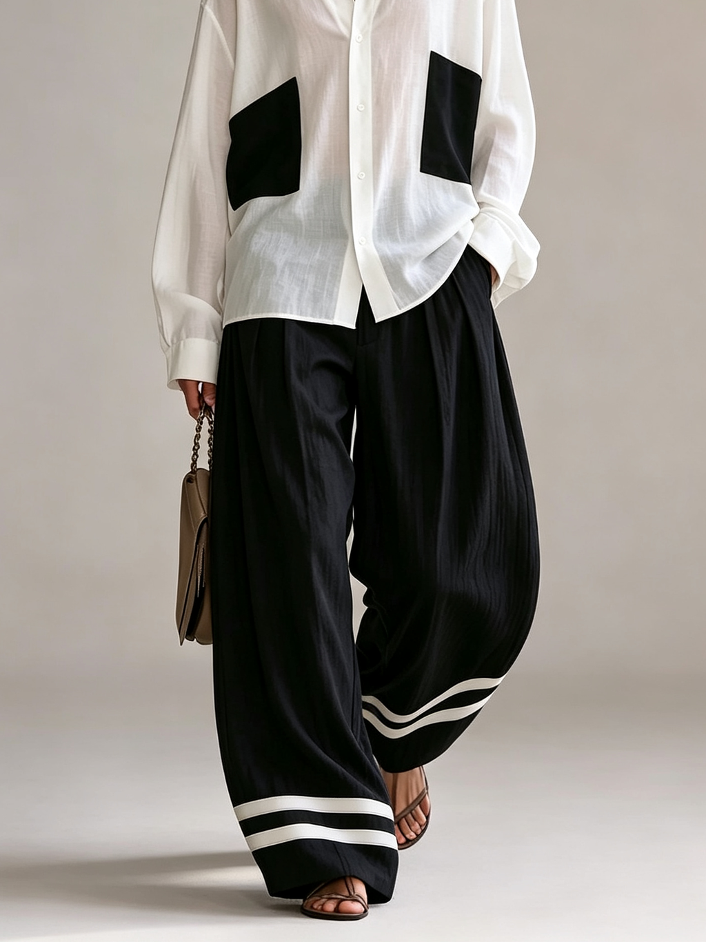 Conjunto Blanco y Negro: Camisa Oversize con Bolsillos de Parche y Pantalón Ancho de Talle Alto con Bajo a Rayas
